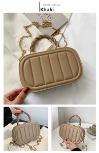 Detailed view of khaki shoulder bag featuring vertical quilted texture and braided handle