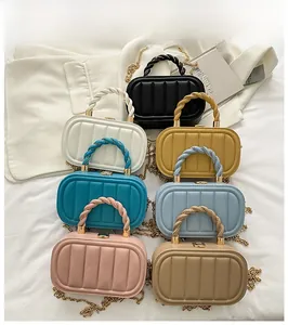 Flat lay of colorful candy-colored hardshell handbags with textured stripes and woven handles