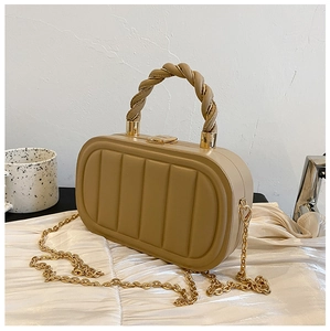 Detail of khaki hardshell handbag with vertical stitching texture and twisted handle