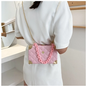 Pink box bag with quilted pattern, gold corner protectors and acrylic chain detail