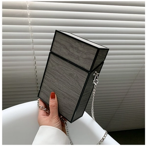 Close-up of grey wood grain box bag with black trim and silver chain strap details