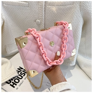 Pink lychee texture box bag with acrylic chain and gold floral hardware detail