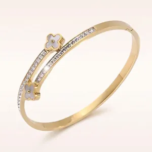 Titanium steel open bangle with double 18K gold clover and white mother of pearl inlay
