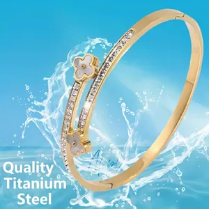 Gold titanium steel bracelet with sparkling clovers and diamonds splashing in water