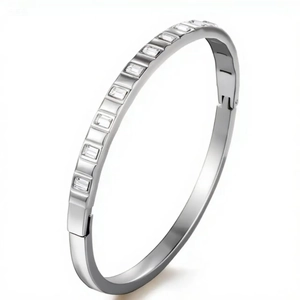 Macro shot of silver stainless steel bangle with channel-set rectangular crystal stones