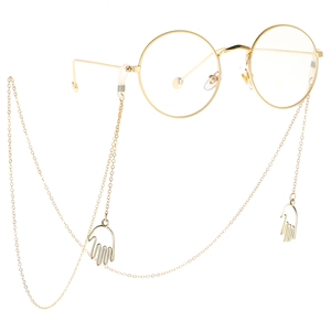 Golden round glasses with stylish metal chain featuring unique palm hand charms