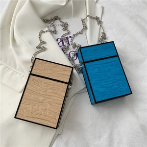 Vertical wooden grain box bags with metal chain straps in natural wood and blue colors