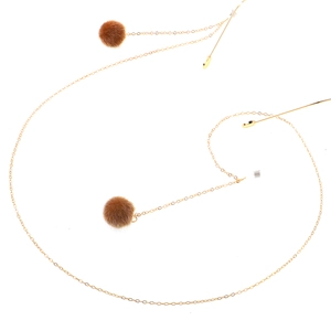 Golden metal eyewear chain featuring decorative brown plush pom-poms on white background