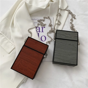 Vertical wood grain box bags in brown and gray with elegant silver chain shoulder straps