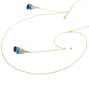 Golden eyewear chain with blue and white gradient tassels shown on a plain white background