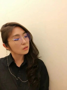 Close-up of oversized gold square glasses with a fine beaded anti-slip metal chain
