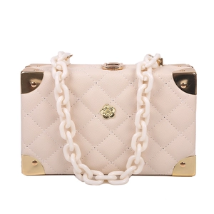 Elegant creamy white quilted box bag with acrylic chain and gold camellia emblem