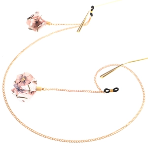 Golden metal eyewear chain with purple floral fabric charms and non-slip rubber loops