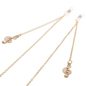 Golden eyewear chain with treble clef charms and crystal accents on a white background