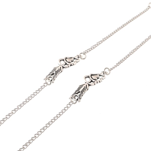 Silver vintage dual-use eyewear chain with heart and feather charms on white background