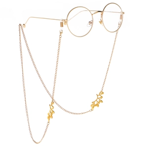 Golden metal eyewear chain with leaf pendants and anti-slip silicone loops on white background