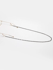 Detail of black beaded glasses chain with gold clasps and white silicone ends