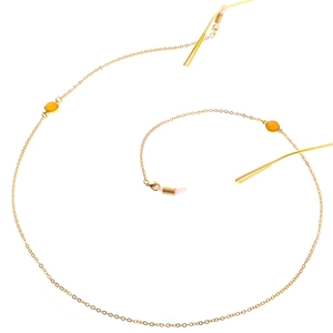 Golden eyeglass chain with yellow beads and silicone anti-slip loops on white background