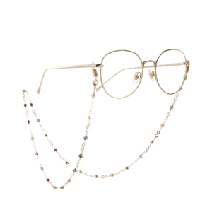 Golden round glasses with colorful rhinestone non-slip chain on white background