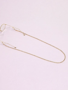 Detail of golden non-slip eyewear chain with rhinestones showing the secure temple grip