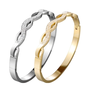 Elegant gold and silver twisted bangles featuring sparkling pavé crystals in 45-degree view