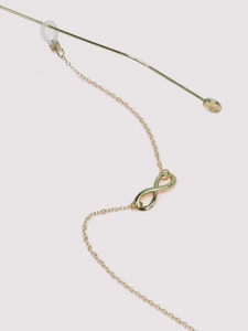 Detail of gold infinity symbol on eyeglasses chain with anti-slip silicone loops