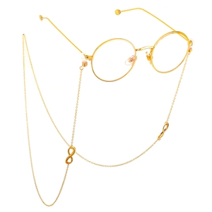Detail of round gold glasses with matching infinity symbol spectacle chain