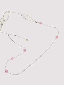 Detail of pink cracked beads and clear pearls on a stylish handmade eyewear chain