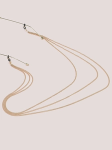 Detail of a triple-layered golden metal eyeglass chain with black silicone loop connectors