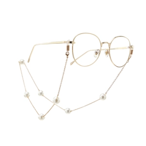 Golden round frame glasses with elegant white faux pearl chain strap on white background