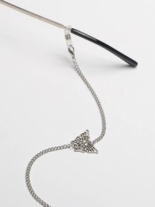 Detail showing the silver butterfly eyewear chain with adjustable silicone loops