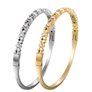 Minimalist gold and silver bracelets with sparkling rhinestones in a sleek layered design