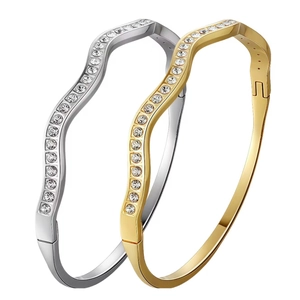 Set of gold and silver wave-shaped stainless steel bangles with sparkling rhinestones