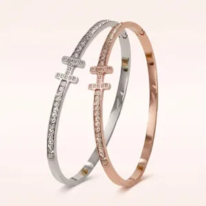 Set of two H-shaped pavé diamond bracelets in gold and silver stainless steel finish