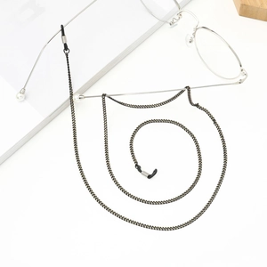 Minimalist black metal eyewear chain with white pearls and anti-slip rubber loops