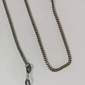 Detail of dark grey metal chain with black rubber anti-slip rings for glasses