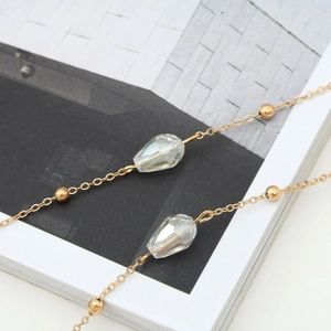 Elegant gold chain eyewear strap with faceted AB crystal teardrops and polished metal beads