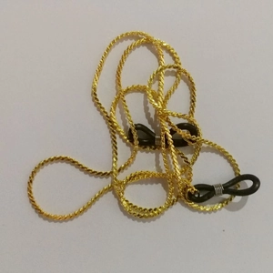 Detail of gold twisted metal chain featuring black rubber anti-slip loops for eyewear