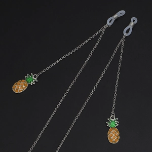 Detail of silver glasses chain featuring yellow pineapple pendants and silicone loops