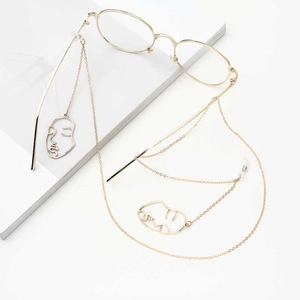 Chic gold round glasses with stylish metal chain and abstract face pendant charms