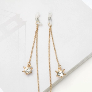 Golden eyewear chain featuring rhinestone crown charms and non-slip rubber loop ends
