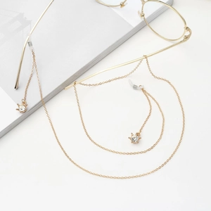 Gold eyeglasses chain featuring rhinestone crown charms and non-slip silicone loops