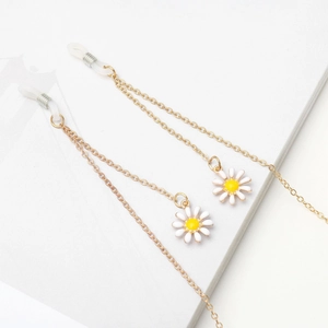 Golden non-slip eyeglass chain with delicate white daisy pendants on minimalist background