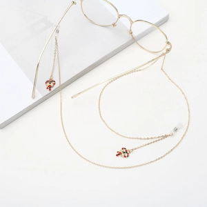 Golden eyewear chain with festive red and green candy cane pendants on a white background