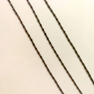 Detailed macro view of black metal bead chain links for sunglasses and eyewear