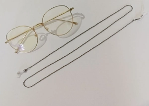 Detail of silver beaded metal eyeglass chain with anti-slip rubber loops and lobster clasp