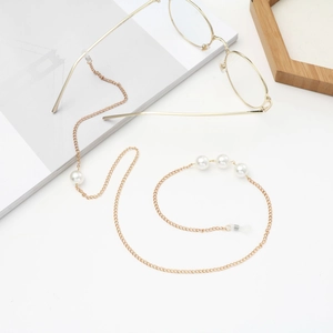 Elegant gold chain eyeglass holder featuring white pearls and flexible silicone ends