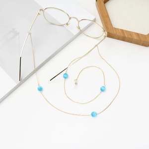 Golden eyeglass chain with blue cat-eye beads on gold frame glasses for women