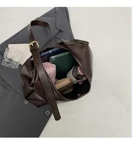 Spacious interior of retro brown tote bag with tablet, umbrella and wallet