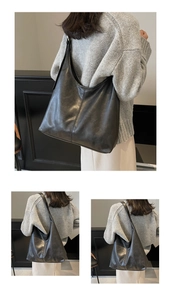 Detailed view of large black oil-wax leather hobo bag with natural vintage texture
